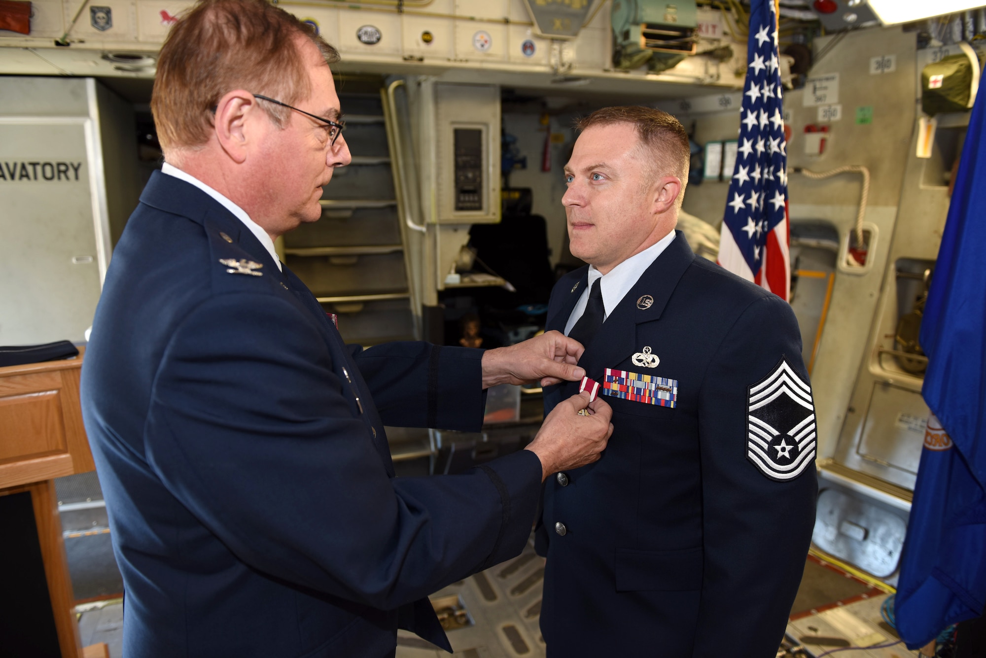 911th Maintenance Group Commander Col. Clifford Waller presents Chief Master Sgt. Timothy J. Stevens with the meritorious service medal during a chief induction ceremony at the Pittsburgh International Airport Air Reserve Station, Pennsylvania, Oct. 5, 2019.