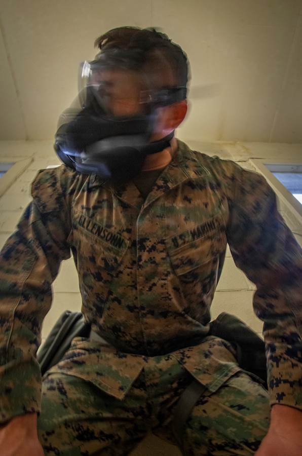 U.S. Marine Corps Cpl. Thomas Ellensohn, a cyber systems administrator with 6th Communication Battalion, Force Headquarters Group, shakes his gas mask during gas chamber training at Marine Corps Base Camp Lejeune, North Carolina, Oct. 22, 2019. The DPC/RSU-East staff provide activated Reserve units/dets various types of training such as gas chamber qualification. During the qualification, Marines are taught chemical, biological, radiological and nuclear threats, reactions to CBRN attacks, and how to take proper care of and use a gas mask. (U.S. Marine Corps photo by Sgt. Andy O. Martinez)