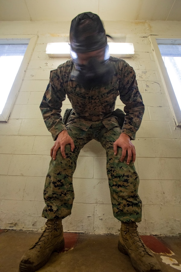 U.S. Marine Corps Cpl. Thomas Ellensohn, a cyber systems administrator with 6th Communication Battalion, Force Headquarters Group, shakes his gas mask during gas chamber training at Marine Corps Base Camp Lejeune, North Carolina, Oct. 22, 2019. The DPC/RSU-East staff conducted gas chamber training, an annual training event, requiring Marines to be exposed to chlorobenzalmalononitrile tablets, also known as CS gas, in order to familiarize themselves with their gas mask. (U.S. Marine Corps photo by Sgt. Andy O. Martinez)