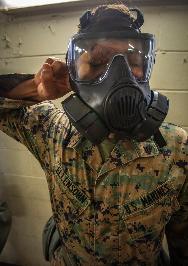 U.S. Marine Corps Cpl. Thomas Ellensohn, a cyber systems administrator with 6th Communication Battalion, Force Headquarters Group, breaks the seal of his gas mask during gas chamber training at Marine Corps Base Camp Lejeune, North Carolina, Oct. 22, 2019. The DPC/RSU-East provided Marine Forces Reserve Marines with chemical, biological, radiological and nuclear defense training in order to build confidence with their gear. (U.S. Marine Corps photo by Sgt. Andy O. Martinez)