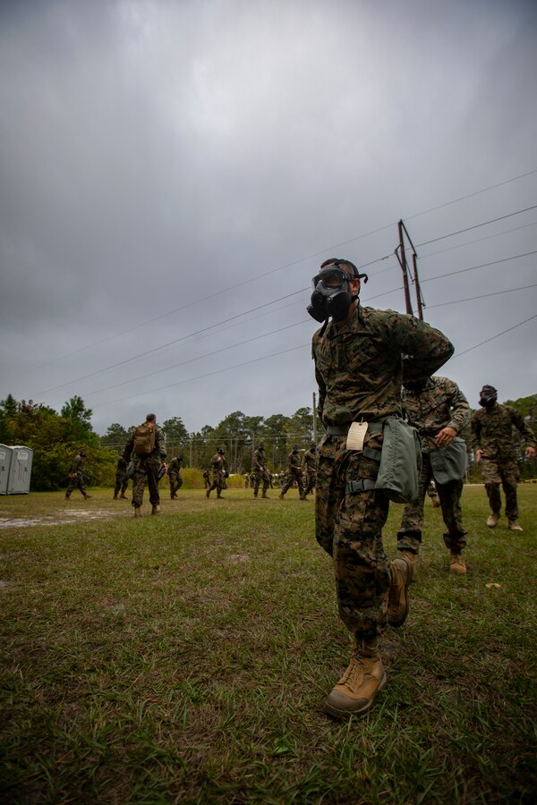 Marines attached to Deployment Processing Command Reserve Support Unit-East, Force Headquarters Group, exit the gas chamber after gas chamber training at Marine Corps Base Camp Lejeune, North Carolina, Oct. 22, 2019. The DPC/RSU-East provided Marine Forces Reserve Marines with chemical, biological, radiological and nuclear defense training in order to build confidence with their gear. (U.S. Marine Corps photo by Sgt. Andy O. Martinez)