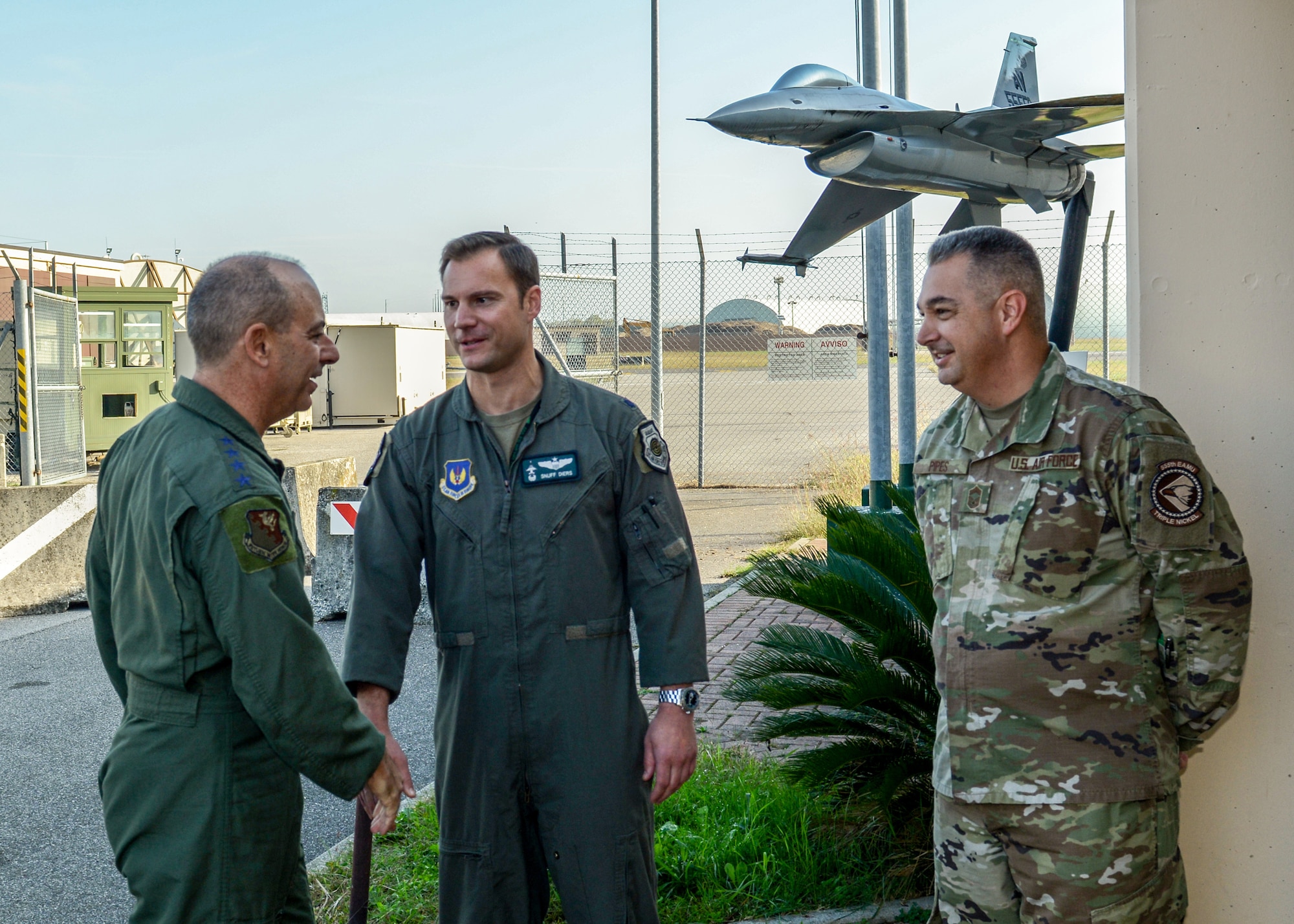 U.S. Air Force Gen. Jeff L. Harrigian, U.S. Air Forces in Europe and Air Forces Africa commander, shakes hands with Chief Master Sgt. Matthew Pipes, 31st Aircraft Maintenance Squadron, 555th Aircraft Maintenance Unit superintendent, at Aviano Air Base, Italy, Oct. 22, 2019.