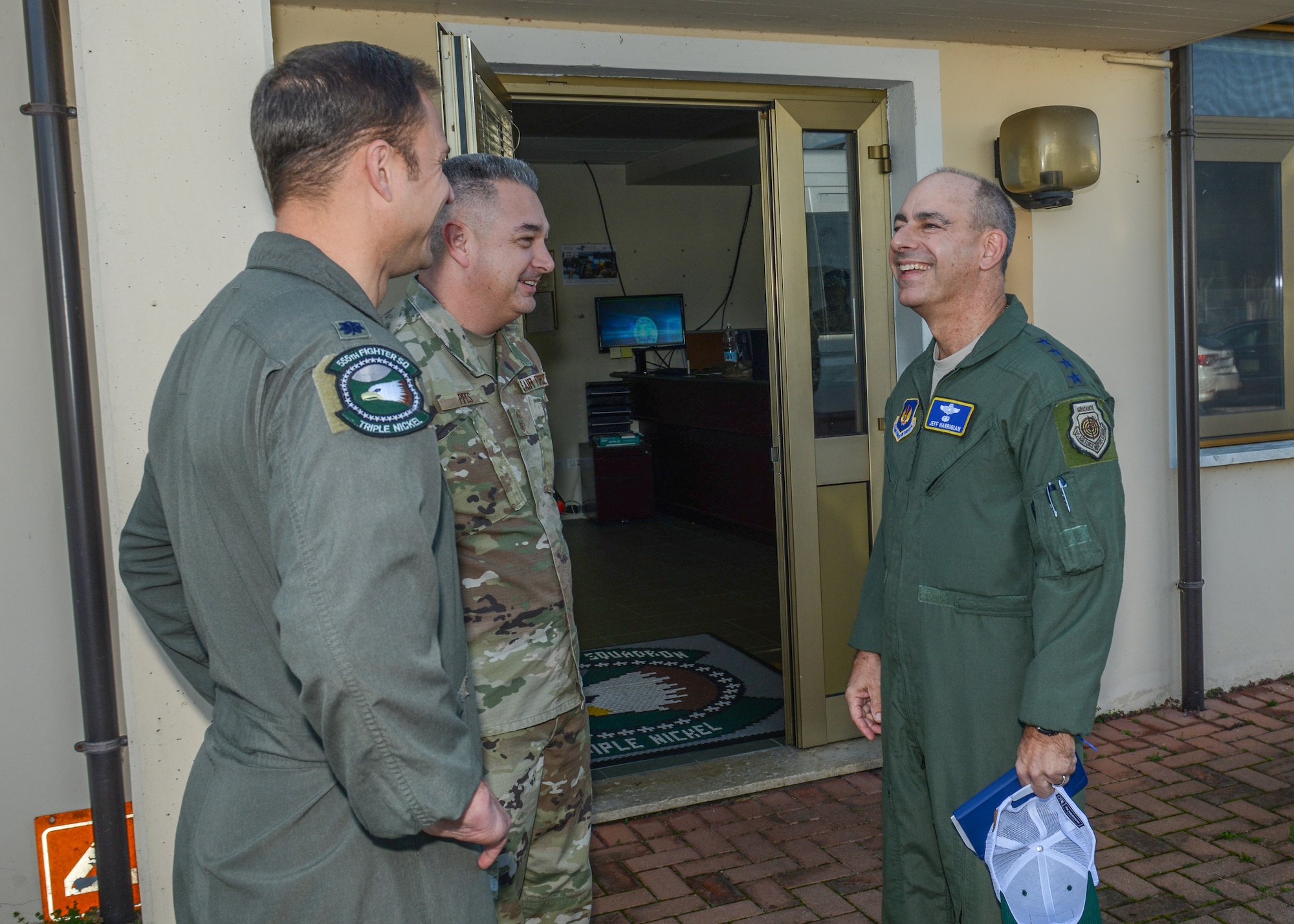 U.S. Air Force Gen. Jeff L. Harrigian, right, U.S. Air Forces in Europe and Air Forces Africa commander, speaks with Chief Master Sgt. Matthew Pipes, middle, 31st Aircraft Maintenance Squadron, 555th Aircraft Maintenance Unit superintendent and Lt. Col. Beau E. Diers, 555th Fighter Squadron commander, at Aviano Air Base, Italy, Oct. 22, 2019.
