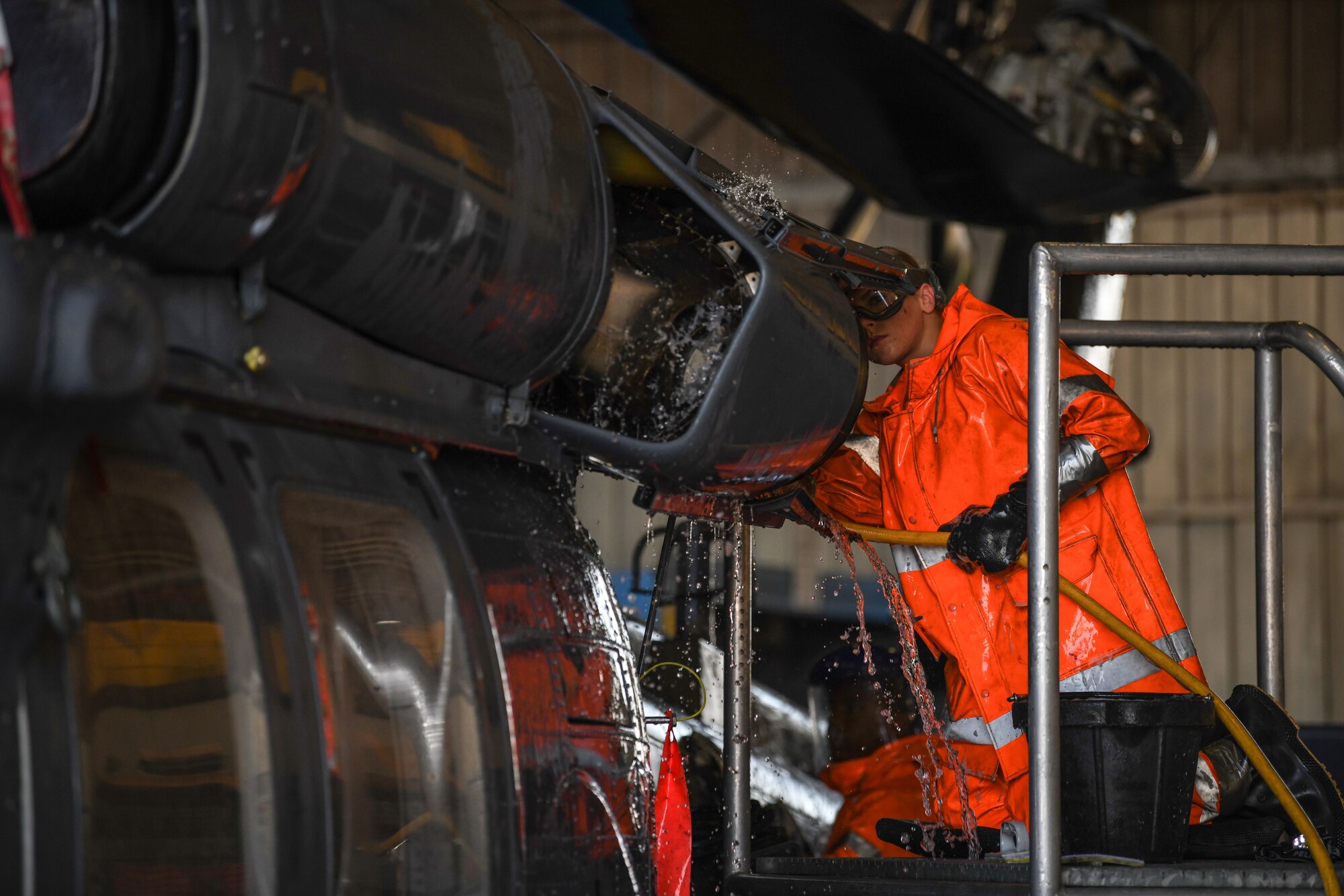U.S Air Force Airman 1st Class Cheyenne Diesbach, an instrument flight control systems specialist from the 31st Aircraft Maintenance Squadron, 56th Helicopter Maintenance Unit, washes the hover infrared suppression system of an HH-60G Pave Hawk helicopter at Aviano Air Base, Italy, Oct. 22, 2019. The wash can take up to eight airmen to complete. (U.S. Air Force photo by Airman 1st Class Ericka A. Woolever).