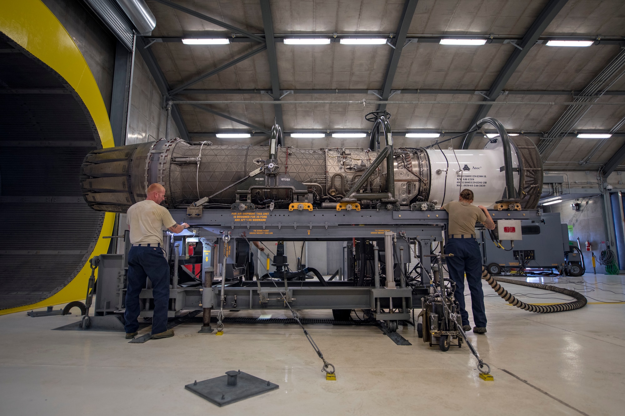 Tech. Sgt. Steven Smart and Tech. Sgt. Stephanie Lunstrom, 49th Component Maintenance Squadron test cell technicians, conduct a pre-inspection, Oct. 17, 2019, on Holloman Air Force Base, N.M. Pre-inspection consists of dressing, loading and hooking connections on the F-16 Viper engine. (U.S. Air Force photo by Staff Sgt. Christine Groening)