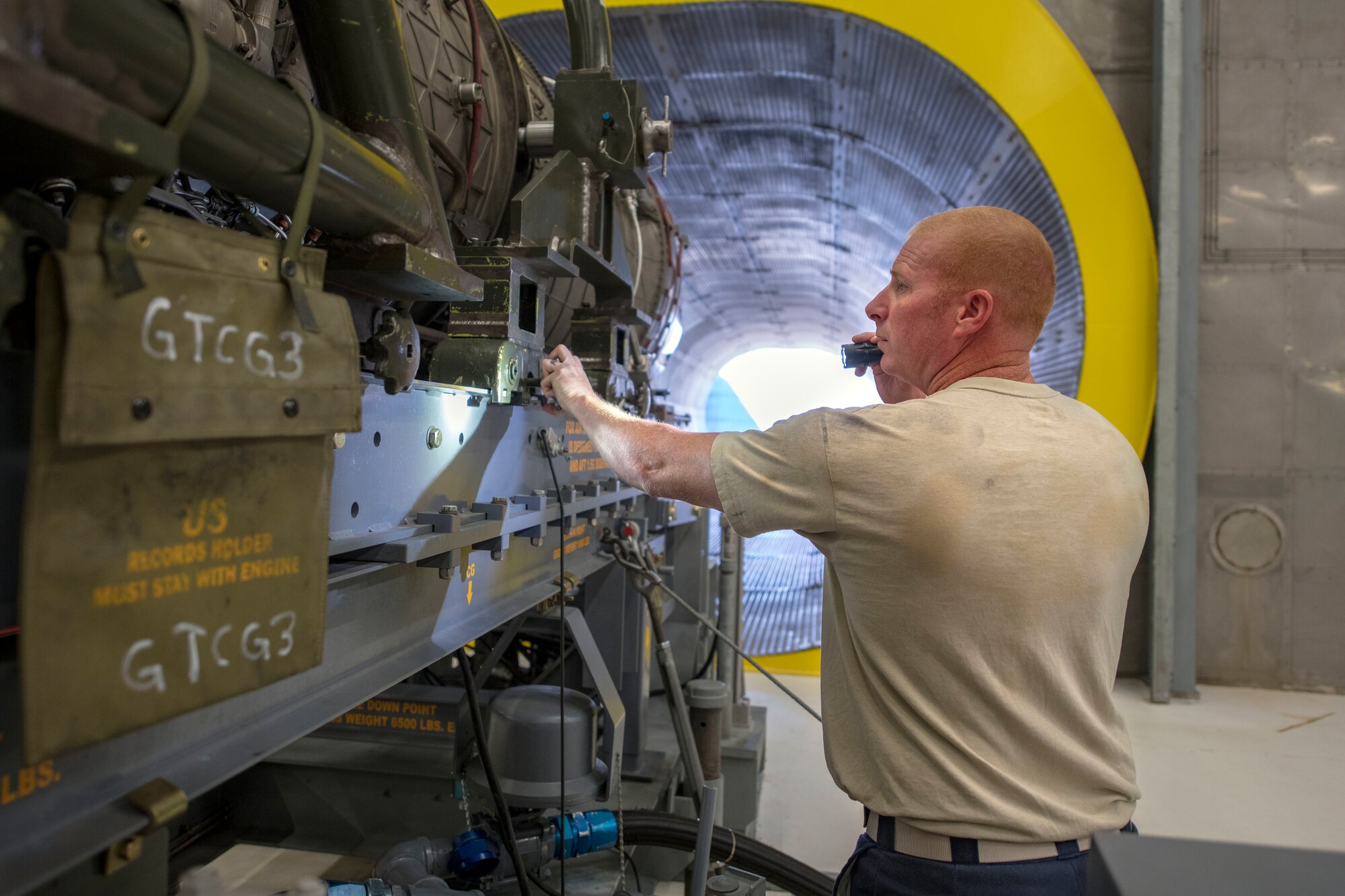Tech. Sgt. Steven Smart, 49th Component Maintenance Squadron test cell noncommissioned officer in charge, inspects an F-16 Viper engine prior to testing, Oct. 17, 2019, on Holloman Air Force Base, N.M. On average, the test cell performs one weekly F-16 engine test. (U.S. Air Force photo by Staff Sgt. Christine Groening)