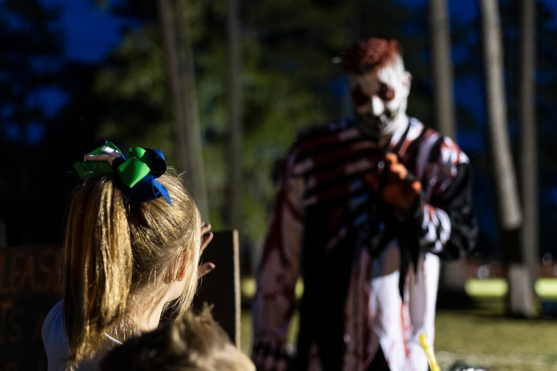 An attendee waves to a performer during the 40th Moooody Haunted House Oct. 18, 2019, in Valdosta, Ga. On average, it takes nearly 1,000 volunteer hours to construct and run the haunted house. It costs nearly $5K for the materials and decorations, and requires a minimum of 24 volunteers per night to operate the haunted house. (U.S. Air Force photo by Airman 1st Class Hayden Legg)