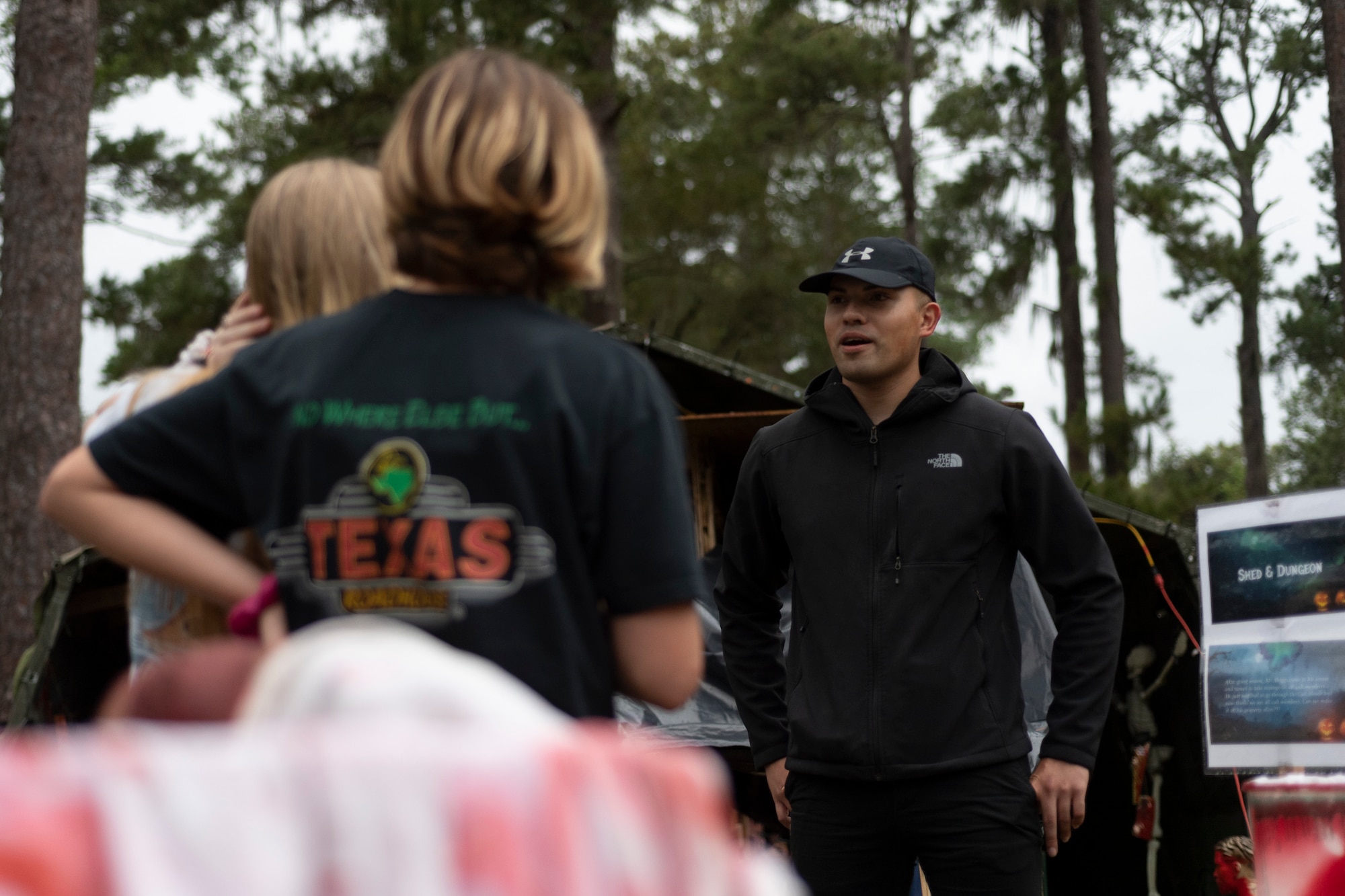 Senior Airman Phillip Pham, 23d Civil Engineer Squadron surveyor, escorts attendees through the 40th Moooody Haunted House Oct. 19, 2019, in Valdosta, Ga. On average, it takes nearly 1,000 volunteer hours to construct and run the haunted house. It costs nearly $5K for the materials and decorations, and requires a minimum of 24 volunteers per night to operate the haunted house. (U.S. Air Force photo by Airman 1st Class Hayden Legg)