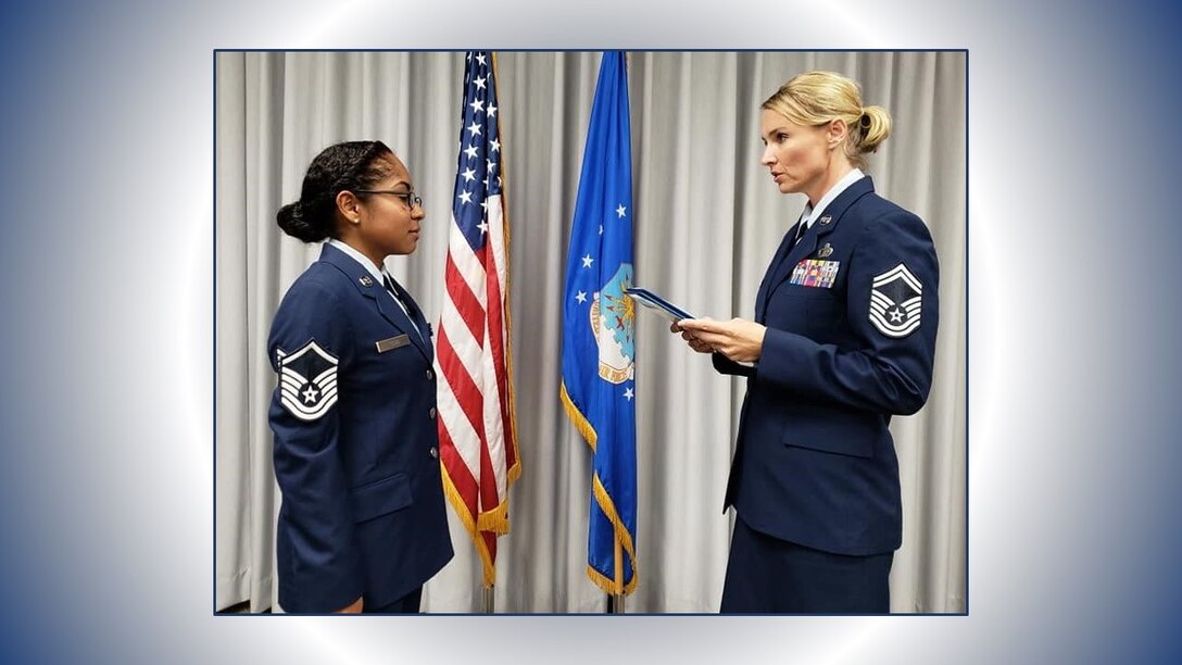 Senior Master Sgt. Laura Garcia, 340th FTG Military Personnel Section superintendent, administers the SNCO oath to new SNCO corps inductee, Master Sgt. Natasha Todd, September 6 at Joint Base San Antonio-Randolph, Texas. (U.S. Air Force photo by Debbie Gildea)