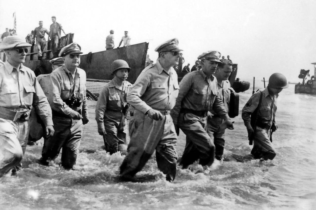 Troops wade ashore.