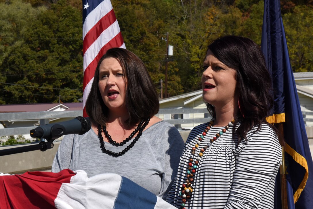 Heather Lewis (Right) and Shana Cornett-Lewis sing the National Anthem Oct. 21, 2019 during the dedication of Shepherd Street Bridge in Cumberland, Ky. The U.S. Army Corps of Engineers Nashville District and contractor Bush & Burchett, Inc., constructed the bridge as part of a flood risk reduction project on Looney Creek. (USACE photo by Lee Roberts)