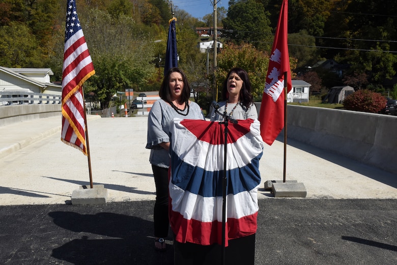 Heather Lewis (Right) and Shana Cornett-Lewis sing the National Anthem Oct. 21, 2019 during the dedication of Shepherd Street Bridge in Cumberland, Ky. The U.S. Army Corps of Engineers Nashville District and contractor Bush & Burchett, Inc., constructed the bridge as part of a flood risk reduction project on Looney Creek. (USACE photo by Lee Roberts)