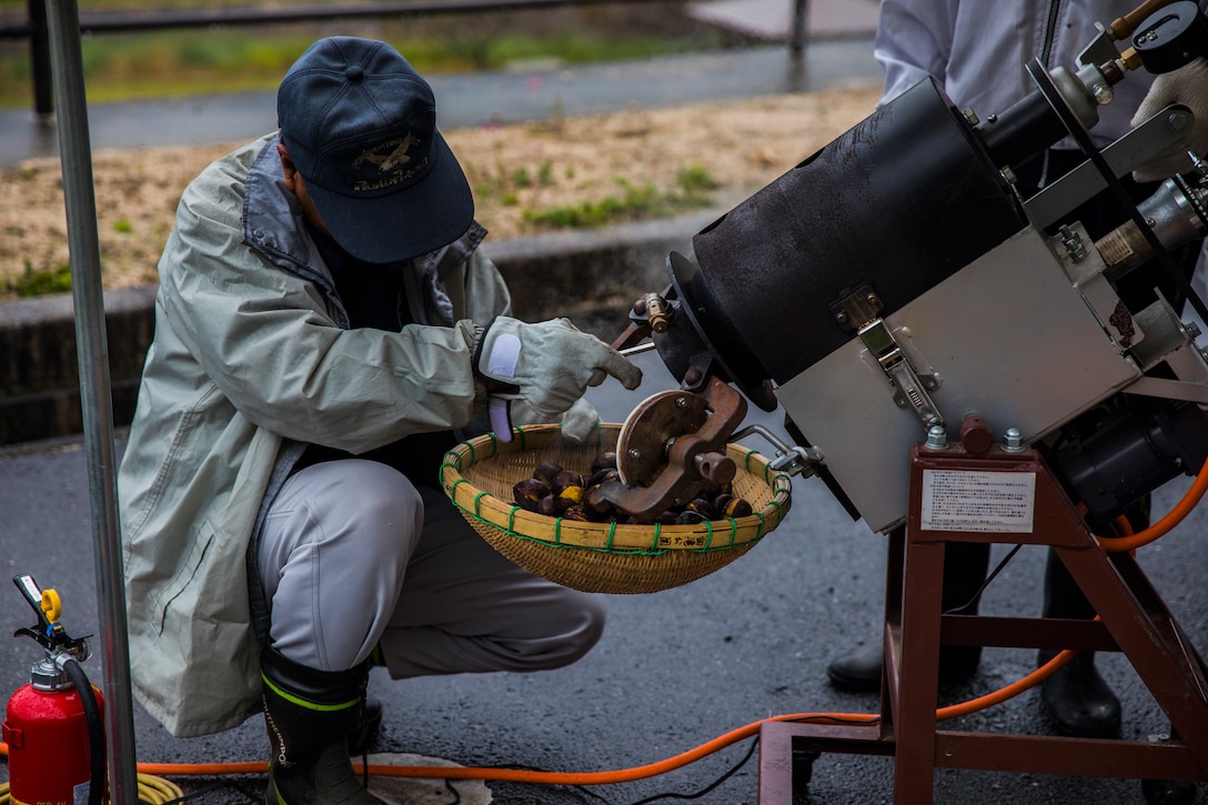 Fujiki Tatsuo, a Japanese local, roasts chestnuts for the participants of the Chestnut Festival in Miwa Town, Japan, Oct. 18, 2019. The Miwa Town Chestnut Festival is held every year to symbolize the end of the chestnut harvest.