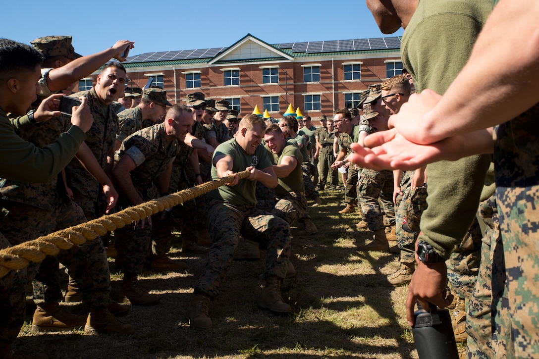 U.S. Marines with Marine Corps Security Force Regiment (MCSFR) participate in tug-of-war competition during a field meet October 18, 2019 at Naval Weapons Station Yorktown, Virginia. The field meet competitions included soccer, flag football, a workout competition, pugil stick bouts, and tug-of-war. The field meet was designed to increase esprit de corps within MCSFR by creating a competitive environment for Marines. (U.S. Marine Corps photo by Sgt. Danielle Prentice/released)