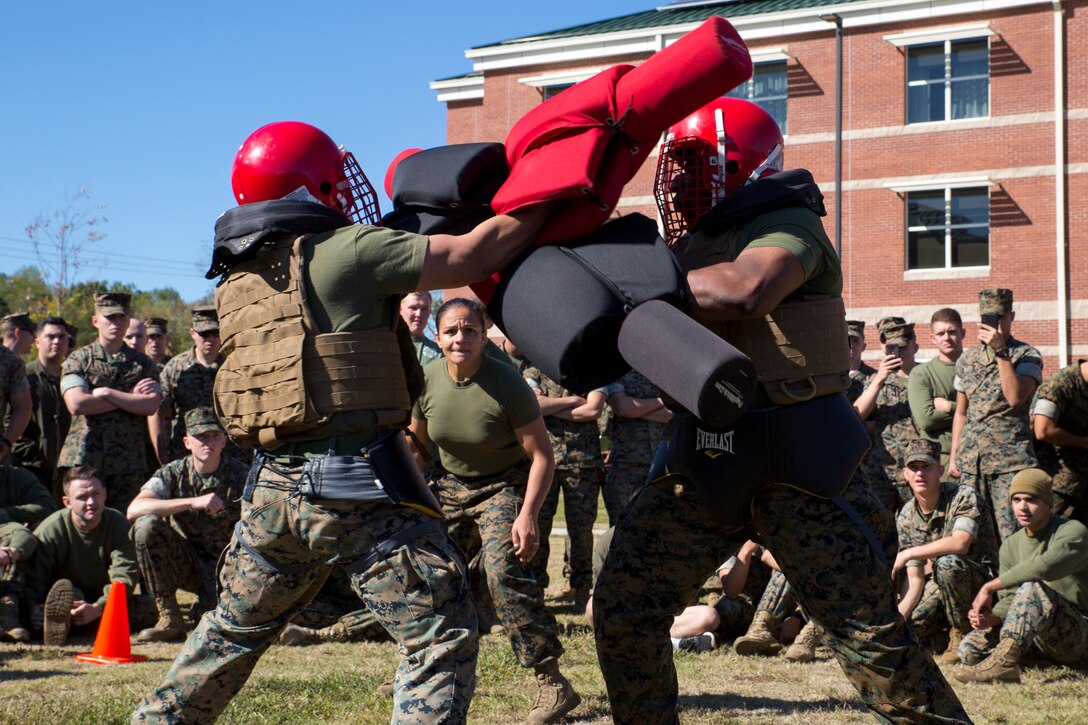U.S. Marines with Marine Corps Security Force Regiment (MCSFR) participate in a pugil stick bout during a field meet October 18, 2019 at Naval Weapons Station Yorktown, Virginia. The field meet competitions included soccer, flag football, a workout competition, pugil stick bouts, and tug-of-war. The field meet was designed to increase esprit de corps within MCSFR by creating a competitive environment for Marines. (U.S. Marine Corps photo by Sgt. Danielle Prentice/released)