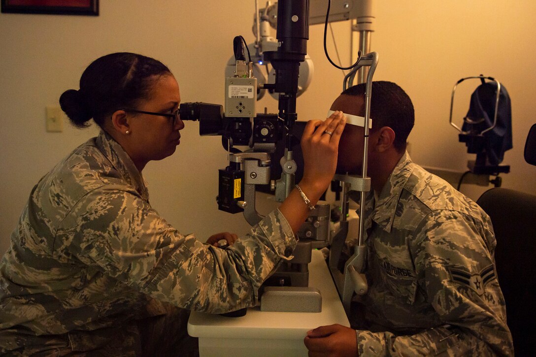 Maj. Stephanie King, 23d Operational Medical Readiness Squadron human performance flight commander, examines a patient Oct. 17, 2019, at Moody Air Force Base, Ga. Optometry technicians perform yearly eye exams to assess Airmen’s vision capabilities and look for signs of eye disorders, such as cataracts or glaucoma. The 23d Medical Group optometry clinic is responsible for maintaining Airman’s ability to see and provides eyewear to those with vision impairments. (U.S. Air Force photo by Airman Azaria E. Foster)