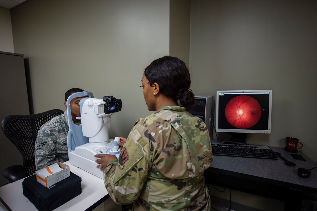 Tech Sgt. Latrisha Skinner, 23d Operational Medical Readiness Squadron optometry technician, performs a retinal examination Oct. 17, 2019, at Moody Air Force Base, Ga. Optometry technicians perform yearly eye exams to assess Airmen’s vision capabilities and look for signs of eye disorders, such as cataracts or glaucoma. The 23d Medical Group optometry clinic is responsible for maintaining Airman’s ability to see and provides eyewear to those with vision impairments. (U.S. Air Force photo by Airman Azaria E. Foster)