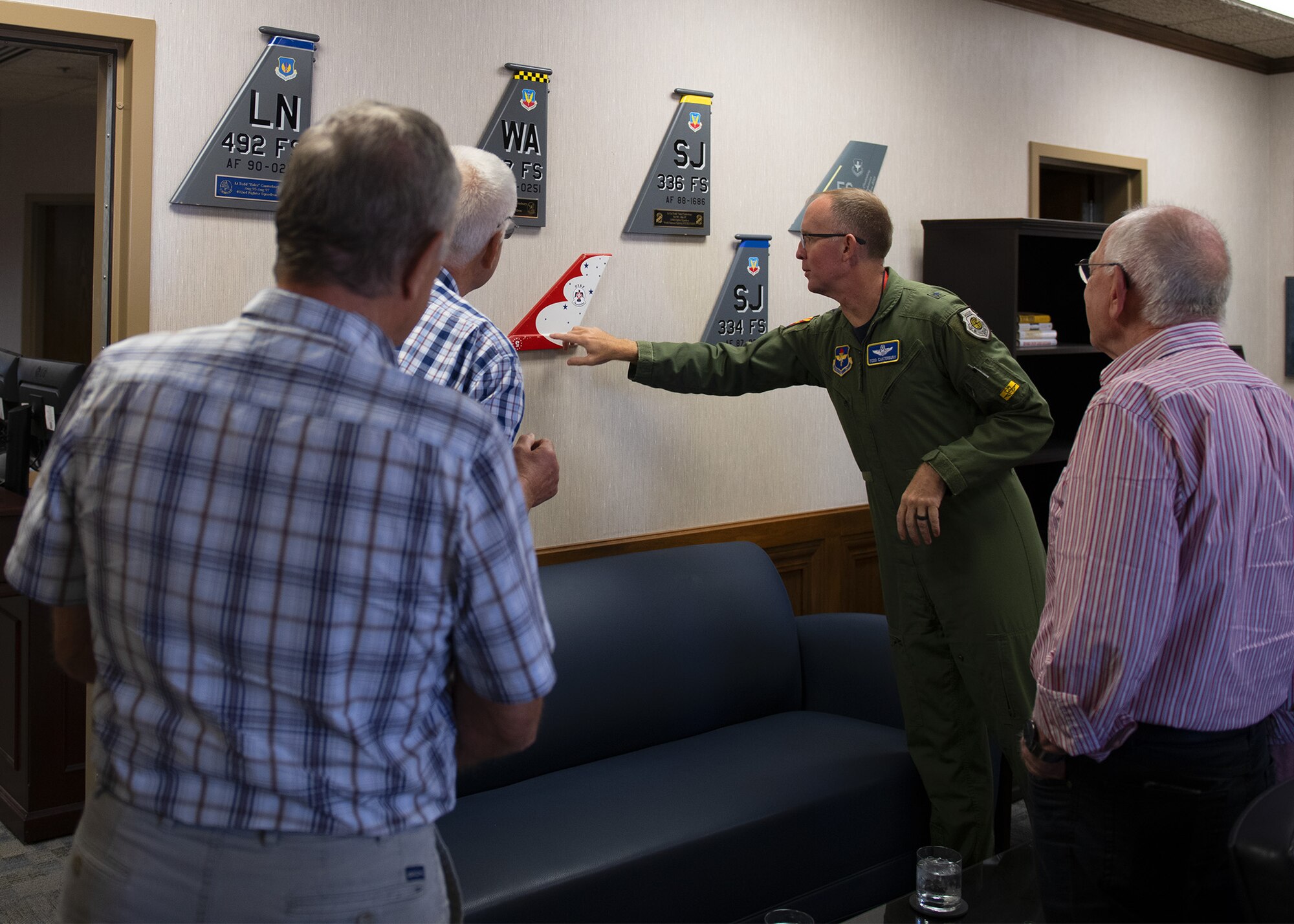 Brig. Gen. Todd Canterbury, 56th Fighter Wing commander, shows his display tail flashes to retired German air force pilots who were part of the Cactus Starfighter Squadron based at Luke from 1958 to 1983.
