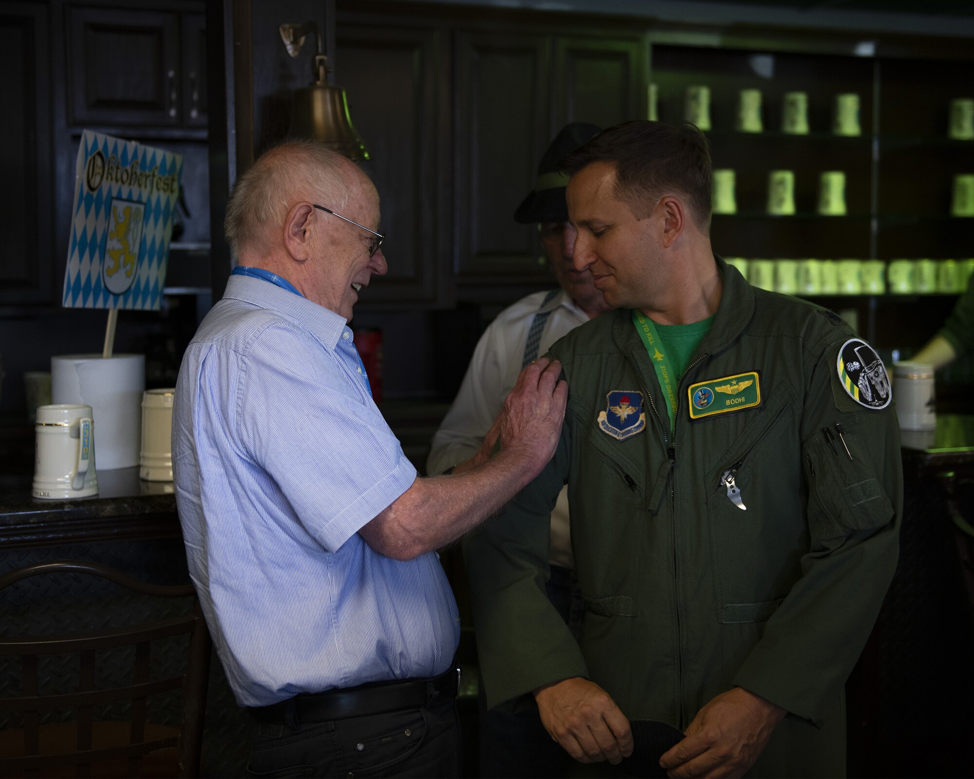 Retired German air force Maj. Gen. Hans Juergen Merkle, former commander of the Cactus Starfighter Squadron, gives Lt. Col. Donald Davenport, 310th Fighter Squadron director of operations, a Cactus Starfighter Squadron patch Oct. 18, 2019, at Luke Air Force Base, Ariz.