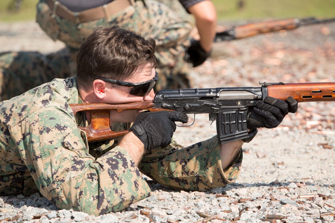 U.S. Marine Corps Gunnery Sgt. John. J. Schaffer, a student in the Marine Corps Security Cooperation Group Marine Advisor Course, fires an SVD, known as the Dragunov, during foreign weapons training in Moyock, North Carolina, Sept. 17, 2019. The range focuses on common foreign security force weapon systems that Marines are likely to encounter when they interact with foreign security forces. It allows them to experience stoppages or malfunctions, and learn how to fix or clear the weapons. (U.S. Marine Corps photo by Sgt. Danielle Prentice)