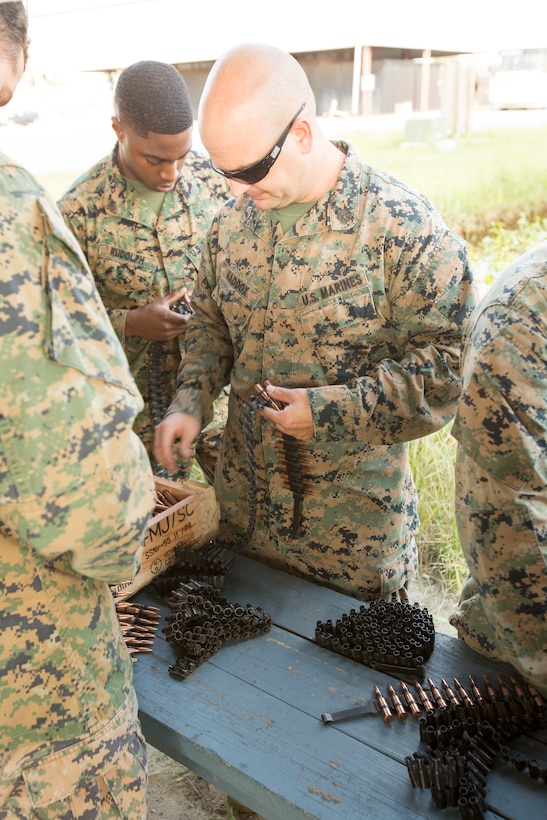 U.S. Marine Corps Staff Sgt. Thomas G. Maddox, a student in the Marine Corps Security Cooperation Group Marine Advisor Course, loads an ammunition belt during foreign weapons training in Moyock, North Carolina, Sept. 17, 2019.