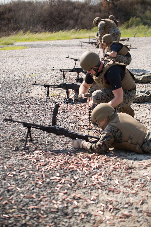 U.S. Marine Corps Sgt. Samuel B. Scott, a foreign weapons instructor with Marine Corps Security Cooperation Group, assists a shooter with a stoppage on a PKM machine gun during foreign weapons training in Moyock, North Carolina, Sept. 17, 2019. The range focuses on common foreign security force weapon systems that Marines are likely to encounter when they interact with foreign security forces. It allows them to experience stoppages or malfunctions, and learn how to fix or clear the weapons.  (U.S. Marine Corps photo by Sgt. Danielle Prentice)