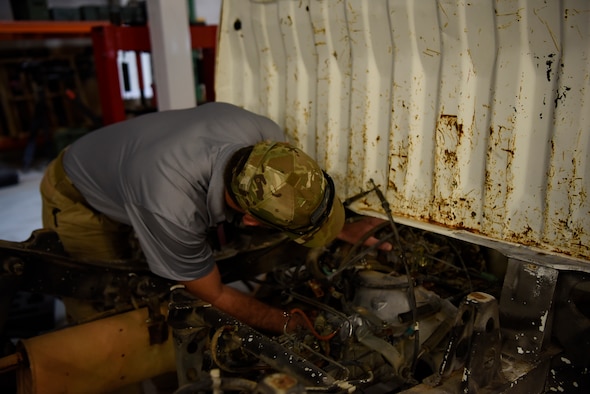 Brian Grady, 27th Special Operations Support Squadron range support operations planning specialist, works on a small truck at Cannon Air Force Base, N.M., Sep. 9, 2019. On top of crafting and creating new equipment, the men and women at the Monster Garage have to maintain and refurbish old and new equipment alike.  (U.S. Air Force photo by Senior Airman Gage Daniel)