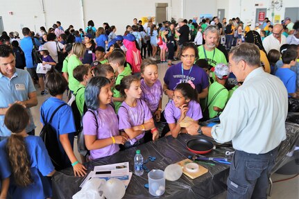 IMAGE: VIRGINIA BEACH, Va. (Sept. 20, 2019) – Scott Gingrich, Naval Surface Warfare Center Dahlgren Division (NSWCDD) physicist, conducts a liquid nitrogen demonstration to a group of fifth graders at Naval Air Station Oceana's fourth annual Science, Technology, Engineering and Mathematics (STEM) Lab. Gingrich was among the scientists and engineers from NSWCDD Dam Neck Activity and NSWCDD who volunteered their time and talents to educate students through hands-on STEM displays throughout the weekend. (U.S. Navy photo by George Bieber/Released)