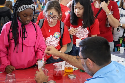 IMAGE: VIRGINIA BEACH, Va. (Sept. 20, 2019) – Scott Polack, Naval Surface Warfare Center Dahlgren Division (NSWCDD) physicist adds food coloring to a student’s slime demonstration. He was among 30 scientists and engineers from Naval Surface Warfare Center Dahlgren Division (NSWCDD) Dam Neck Activity and NSWCDD who educated students through hands-on displays at Naval Air Stations Oceana’s fourth annual Science, Technology, Engineering and Mathematics Lab. (U.S. Navy photo by George Bieber/Released)