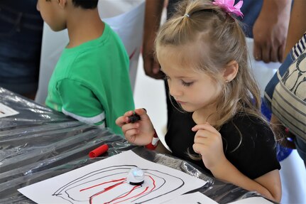 IMAGE: VIRGINIA BEACH, Va. (Sept. 20, 2019) – One of 7,000 fifth-graders from Chesapeake and Virginia Beach elementary schools watches an Ozobot follow her hand-drawn path at Naval Air Station Oceana’s fourth annual Science, Technology, Engineering and Mathematics (STEM) Lab. The event broke the Guinness World Record for the largest field trip on record. More than 30 scientists and engineers from Naval Surface Warfare Center Dahlgren Division (NSWCDD) Dam Neck Activity and NSWCDD volunteered their time and talents to educate the students through hands-on STEM displays. (U.S. Navy photo by George Bieber/Released)