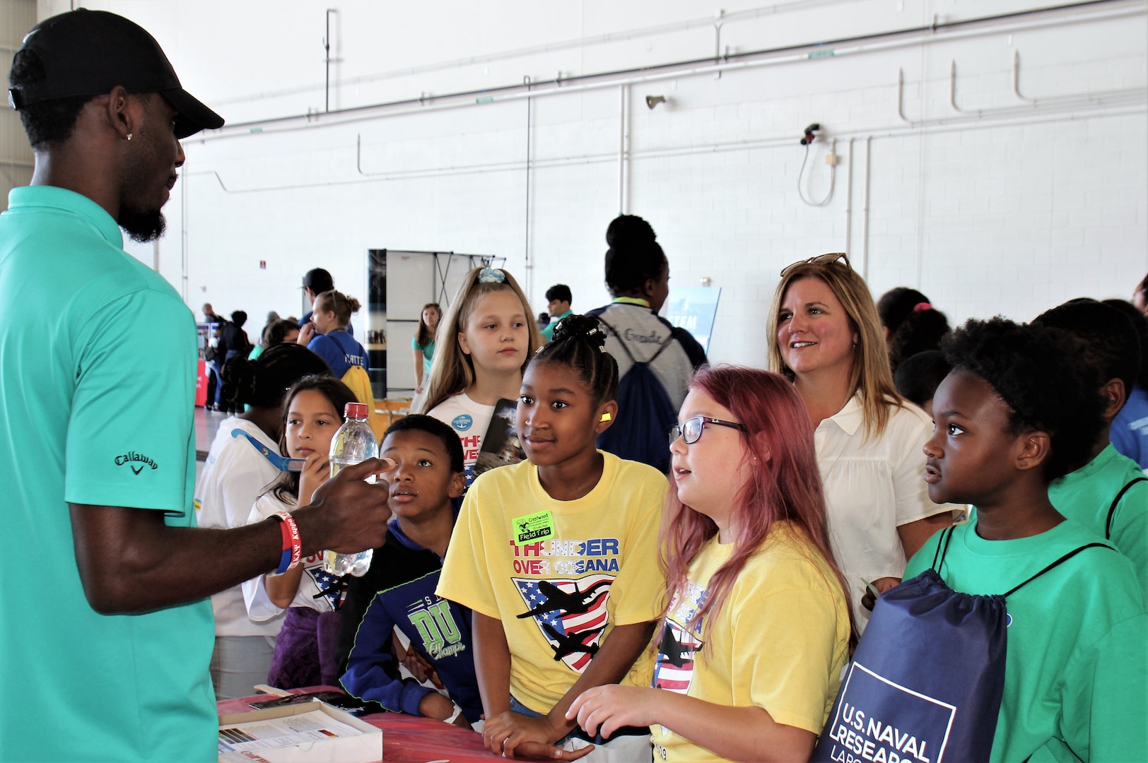 IMAGE: VIRGINIA BEACH, Va. (Sept. 20, 2019) – Devon McKiver, Naval Surface Warfare Center Dahlgren Division (NSWCDD) scientist, explains a water bottle demonstration to students at Naval Air Stations Oceana’s fourth annual Science, Technology, Engineering and Mathematics (STEM) Lab. He was among 30 scientists and engineers from Naval Surface Warfare Center Dahlgren Division (NSWCDD) Dam Neck Activity and NSWCDD who volunteered their time and talents to educate students through hands-on STEM displays. (U.S. Navy photo by George Bieber/Released)