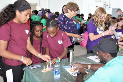 IMAGE: VIRGINIA BEACH, Va. (Sept. 20, 2019) – Devon McKiver, Naval Surface Warfare Center Dahlgren Division (NSWCDD) scientist, explains a puzzle demonstration to students at Naval Air Station Oceana’s fourth annual Science, Technology, Engineering and Mathematics (STEM) Lab. He was among 30 scientists and engineers from Naval Surface Warfare Center Dahlgren Division (NSWCDD) Dam Neck Activity and NSWCDD who volunteered their time and talents to educate students through hands-on STEM displays.  (U.S. Navy photo by George Bieber/Released)