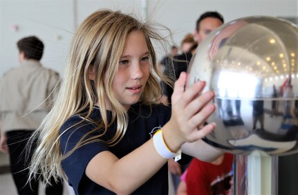 IMAGE: VIRGINIA BEACH, Va. (Sept. 20, 2019) – One of 7,000 fifth-graders from Chesapeake and Virginia Beach elementary schools touches a static electricity demonstration causing her hair to standup at Naval Air Station Oceana’s fourth annual Science, Technology, Engineering and Mathematics (STEM) Lab. The event broke the Guinness World Record for the largest field trip on record. More than 30 scientists and engineers from Naval Surface Warfare Center Dahlgren Division (NSWCDD) Dam Neck Activity and NSWCDD volunteered their time and talents to educate the students through hands-on STEM displays. (U.S. Navy photo by George Bieber/Released)