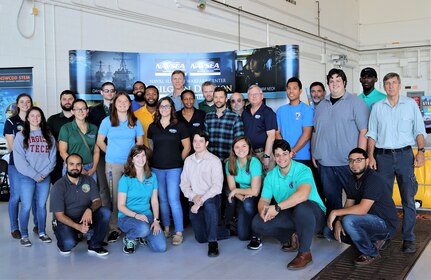 IMAGE: VIRGINIA BEACH, Va. (Sept. 20, 2019) – Scientists and engineers from Naval Surface Warfare Center, Dahlgren Division (NSWCDD) Dam Neck Activity and NSWCDD are pictured at Naval Air Station Oceana’s fourth annual Science, Technology, Engineering and Mathematics (STEM) Lab. They volunteered their time and talents to educate students through hands-on Science, Technology, Engineering and Mathematics (STEM) displays. More than 7,000 fifth-graders from Chesapeake and Virginia Beach elementary schools participated in the event, breaking the Guinness World Record for the largest field trip on record.  (U.S. Navy photo by George Bieber/Released)