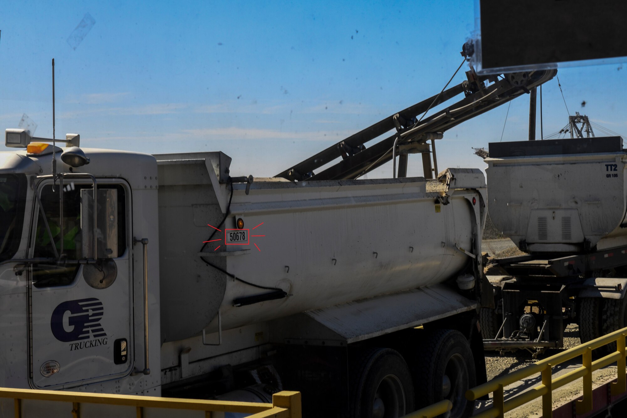 A contracted truck driver communicates with the weight master his information in Marysville, California, Oct. 10, 2019. Some indicators that can be used to identify a truck would be the five digit number (circled in red) that allows you to contact the company about any incident (U.S. Air Force Photo by Senior Airman Colville McFee)