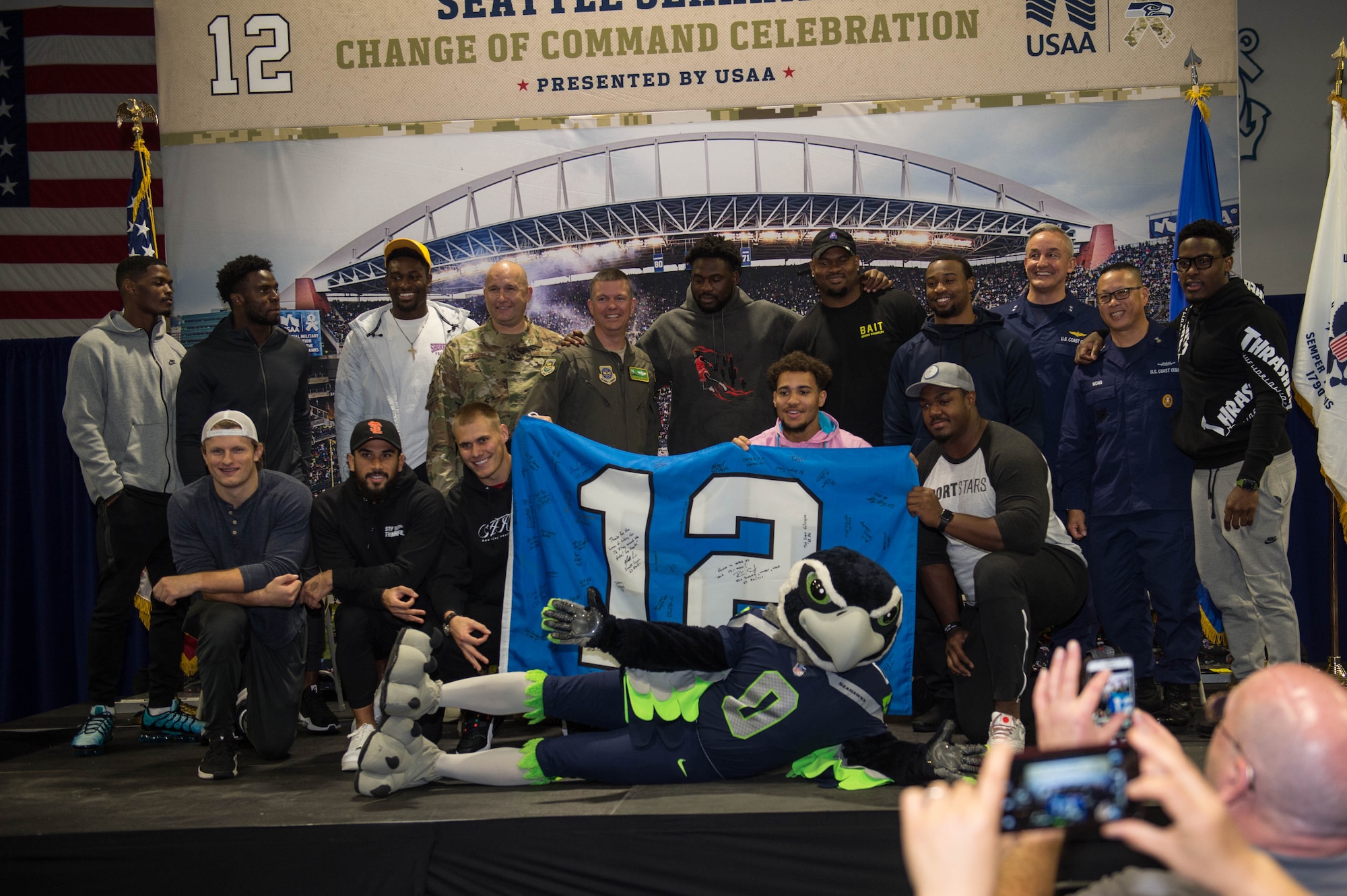 Seattle Seahawks players pose with leadership from the 62nd Airlift Wing and the 13th Coast Guard District at Coast Guard Base Seattle, Wash., Oct. 22, 2019.
