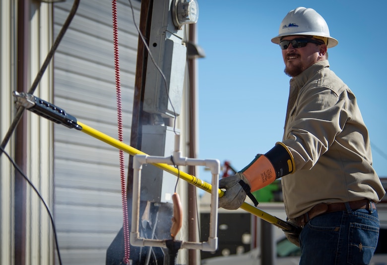 SCHRIEVER AIR FORCE BASE, Colo. – Zeb Birch, Mountain View Electric Association journey lineman, demonstrates the importance of proper safety equipment when touching an electrical pole wire during a training session at Schriever Air Force Base, Colorado, Oct. 22, 2019. Birch used a hotdog to simulate human flesh for the demonstration, after contact was made with the wire - the hotdog exploded. (U.S. Air Force photo by Airman 1st Class Jonathan Whitely)