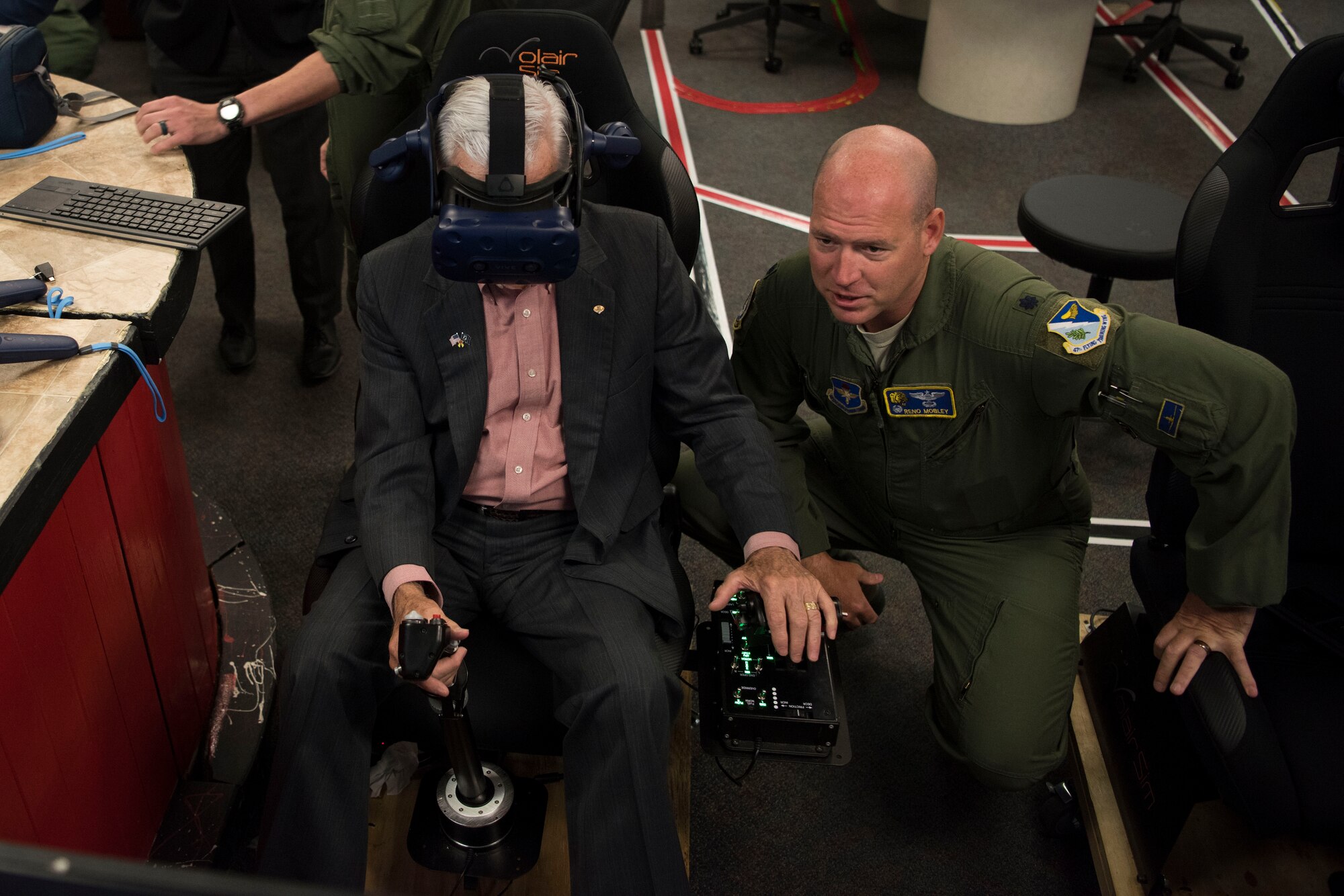 Lt. Col. Gentry Mobley, 85th Flying Training Squadron commander, gives retired Lt. Col. Barry Bridger, former Prisoner of War, guidance on a virtual flight simulator at Laughlin Air Force Base, Texas, Oct. 23, 2019. Mobley gave Bridger a tour of the innovative technology student pilots get to interact with. (U.S. Air Force photo by Senior Airman Marco A. Gomez)
