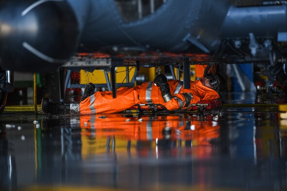 U.S Air Force Airman James Eyler, a crew chief from the 31st Aircraft Maintenance Squadron, 56th Helicopter Maintenance Unit, washes under an HH-60G Pave Hawk helicopter at Aviano Air Base, Italy, Oct. 22, 2019. The primary mission of the HH-60G Pave Hawk helicopter is to conduct day or night personnel recovery operations within hostile environments. (U.S. Air Force photo by Airman 1st Class Ericka A. Woolever).