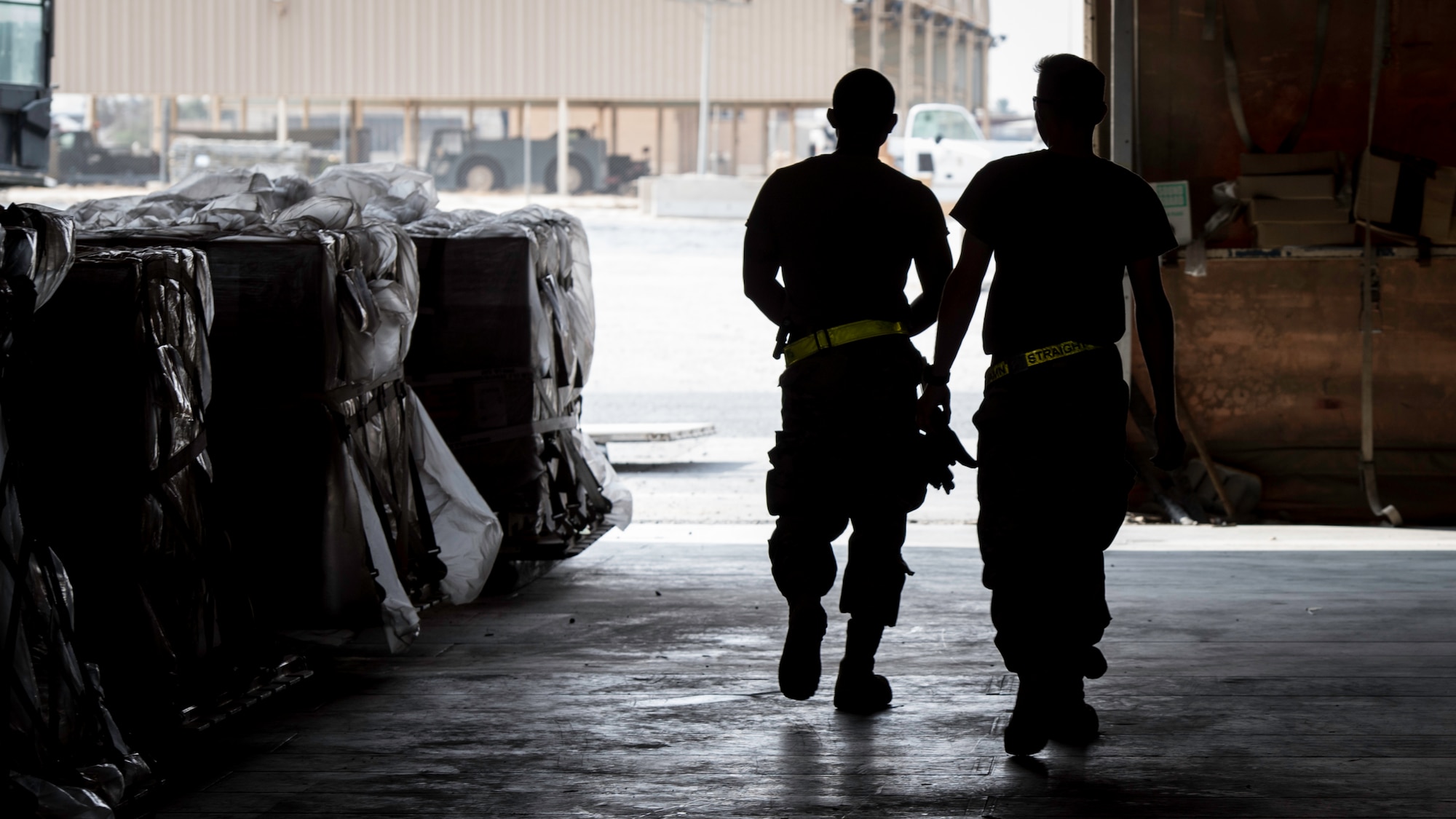 Staff Sgt. Samuel Johnson and Senior Airman Dalton McWilliams, 386th Expeditionary Logistics Readiness Squadron aerial port cargo processing representatives, walk by fully assembled, ready to transport pallets at Ali Al Salem Air Base, Kuwait, Oct. 17, 2019. Port Dawgs handled over 4,000 tons of inbound and outbound cargo in the month of September alone.