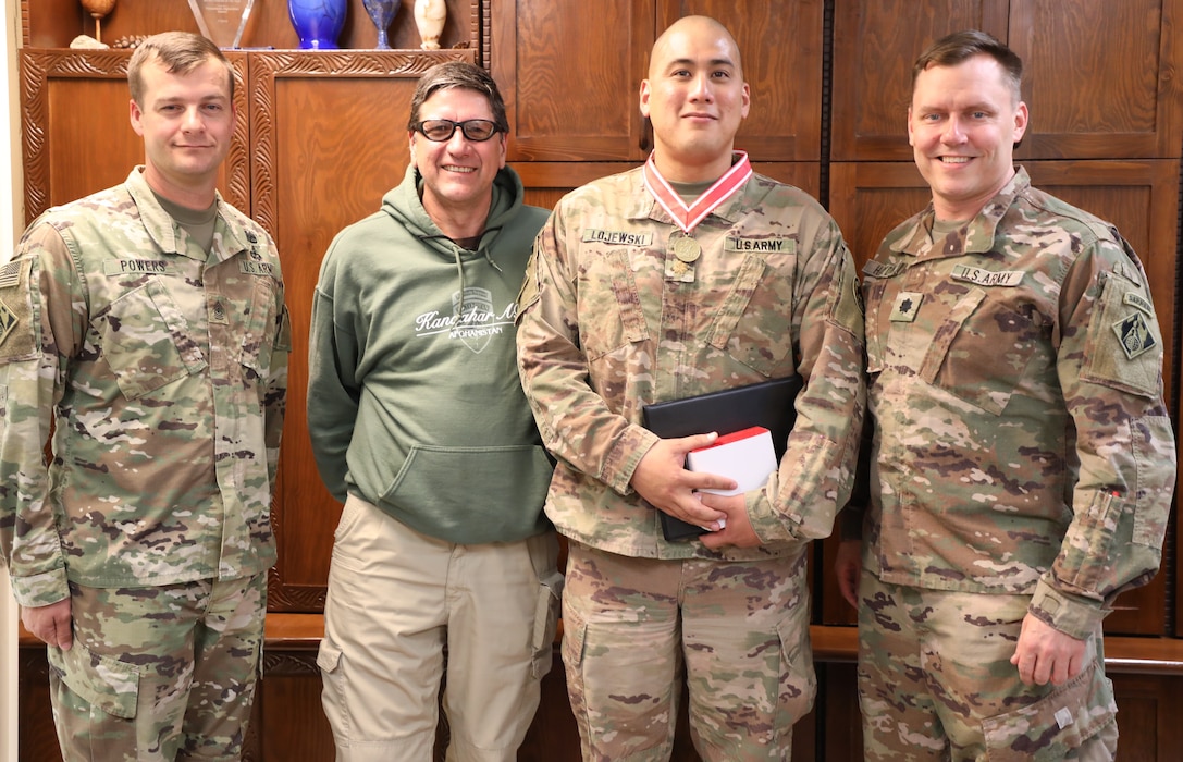 Army Maj. Mark Lojewski (2nd from right) wears his newly presented Bronze de Fleury Medal. Lojewski received the medal from Army Lt. Col. Dan Hayden, USACE Afghanistan District deputy commander (right) during a ceremony on Bagram Airfield, Afghanistan, on Oct. 22, 2019. Also pictured are Afghanistan District Senior Enlisted Advisor Sergeant Maj. Anthony Powers (left) and Lojewski’s supervisor James Root, who nominated Lojewski for the award. The de Fleury Medal is one of the highest awards a member of the U.S. Army Corps of Engineers can receive and is presented to only a few Soldiers every year.
