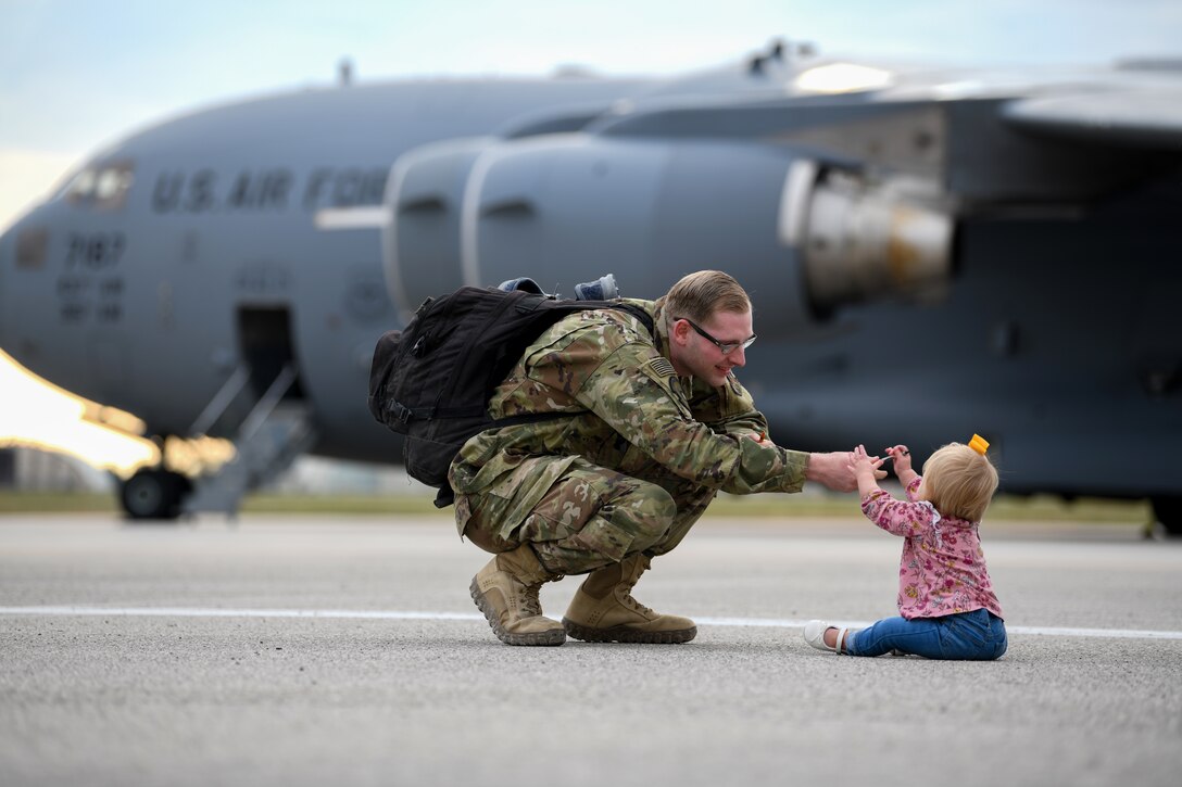 U.S Airmen plays with his daughter as he reunites with his family after a deployment at Aviano Air Base, Italy, Oct. 8, 2019. The HH-60G is also tasked to perform military operations other than war, including civil search and rescue, medical evacuation, disaster response, humanitarian assistance, security cooperation/aviation advisory, NASA space flight support, and rescue command and control. (U.S. Air Force photo by Airman 1st Class Ericka A. Woolever).