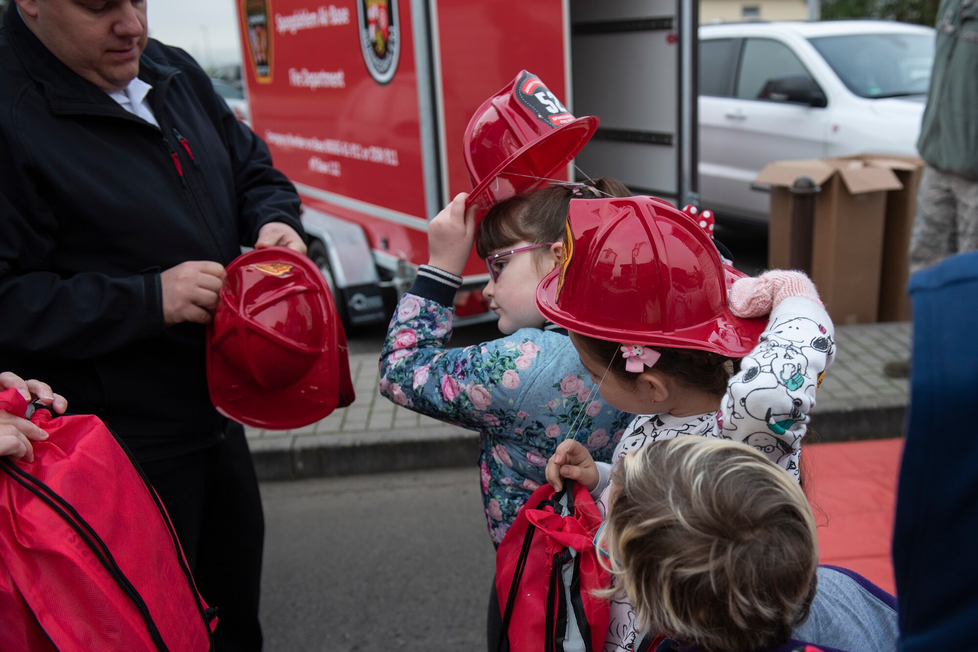 Spangdahlem Elementary School students receive commemorative 52nd Civil Engineer Squadron firefighter helmets for Fire Prevention Week at Spangdahlem Air Base, Germany, Oct. 23, 2019. Students were able to try on gear, sit in a fire truck, and practice calling the fire department in case of a fire. (U.S. Air Force photo by Airman 1st Class Alison Stewart)