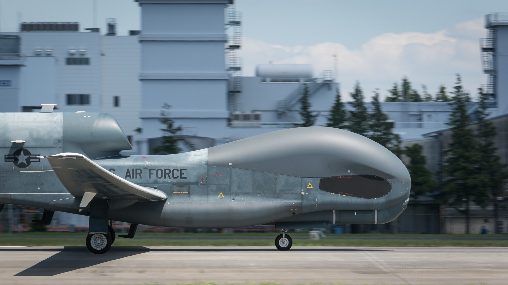 An RQ-4 Global Hawk, assigned to the 319th Operations Group, Detachment 1, Andersen Air Force Base, Guam, lands at Yokota Air Base, Japan, Aug. 5, 2019, for a rotational deployment. The movement maintains operations for Global Hawks during months of inclement weather endured at Andersen AFB, such as typhoons and other scenarios which have the potential to hinder readiness. (U.S. Air Force photo by Senior Airman Juan Torres)