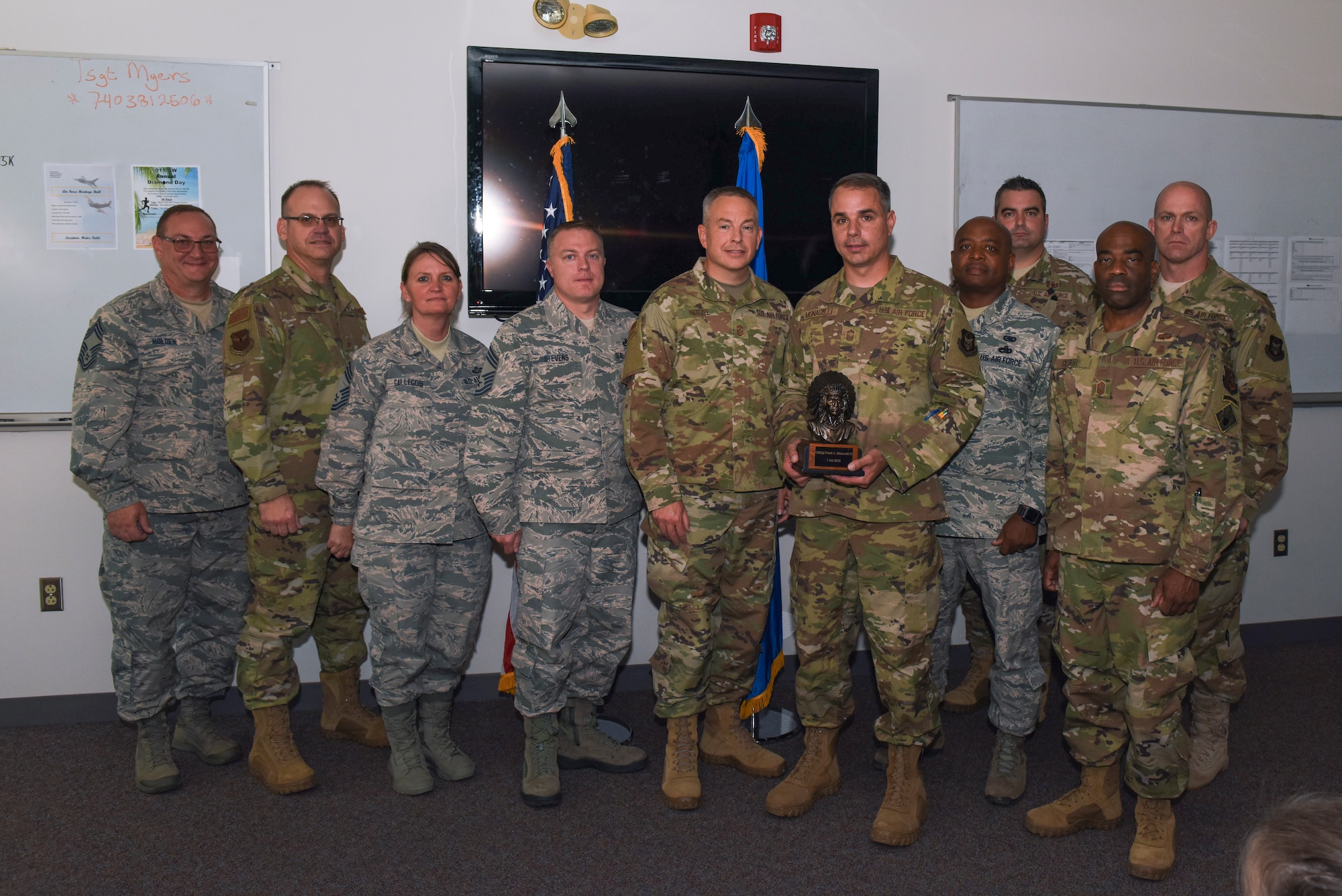 The 911th Airlift Wing Chief’s Council presents Chief Master Sgt. Frank Monacelli, superintendent of the 911th Civil Engineering Squadron, with the Chief’s Bust during a promotion ceremony at the Pittsburgh International Airport Air Reserve Station, Pennsylvania, Oct. 5, 2019.