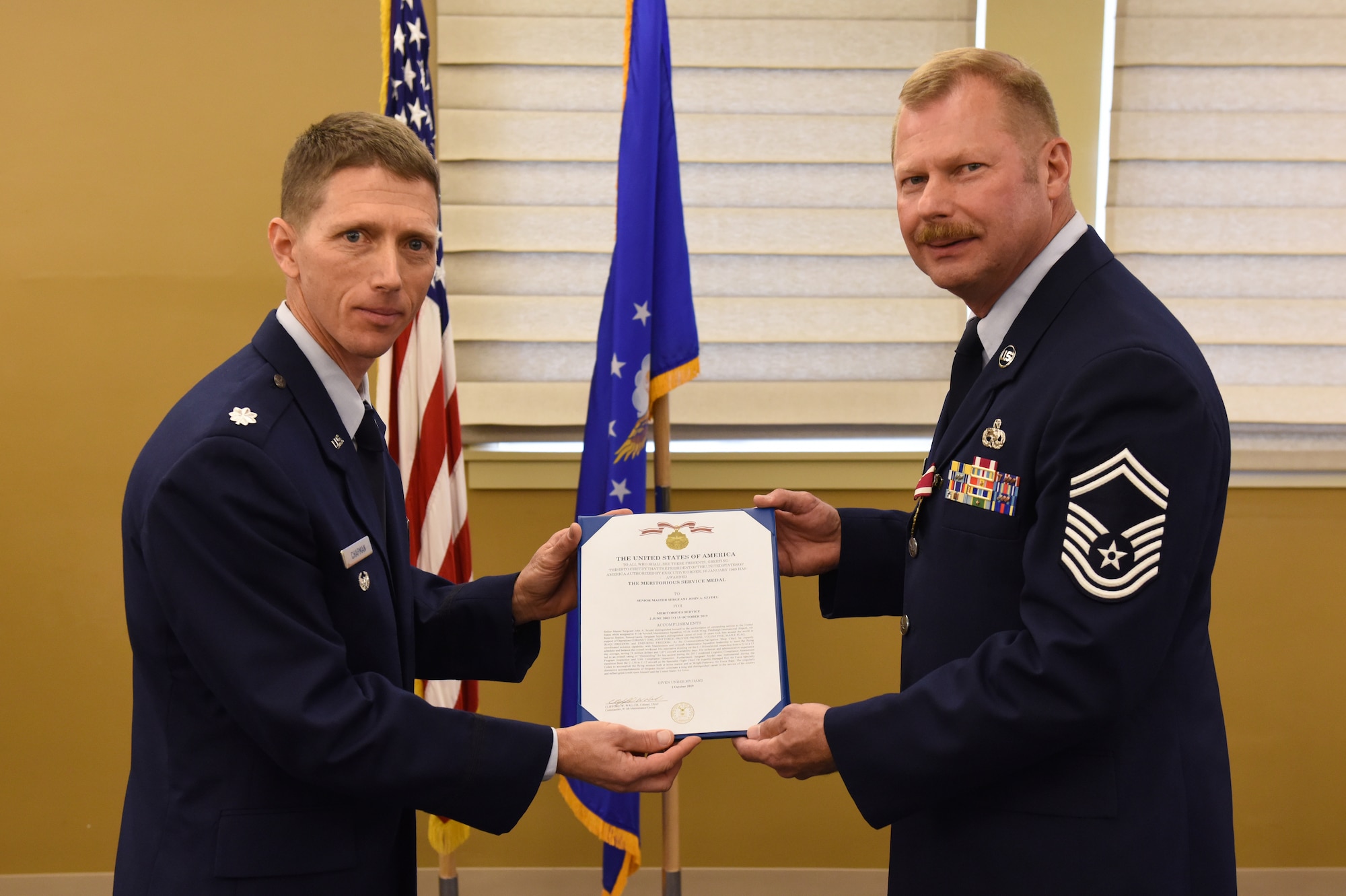 911th Maintenance Group Deputy Commander Lt. Col. William Chapman, left, presents Senior Master Sgt. John A. Szydel with a meritorious service medal citation during a retirement ceremony at the Pittsburgh International Airport Air Reserve Station, Pennsylvania, Oct. 5, 2019.