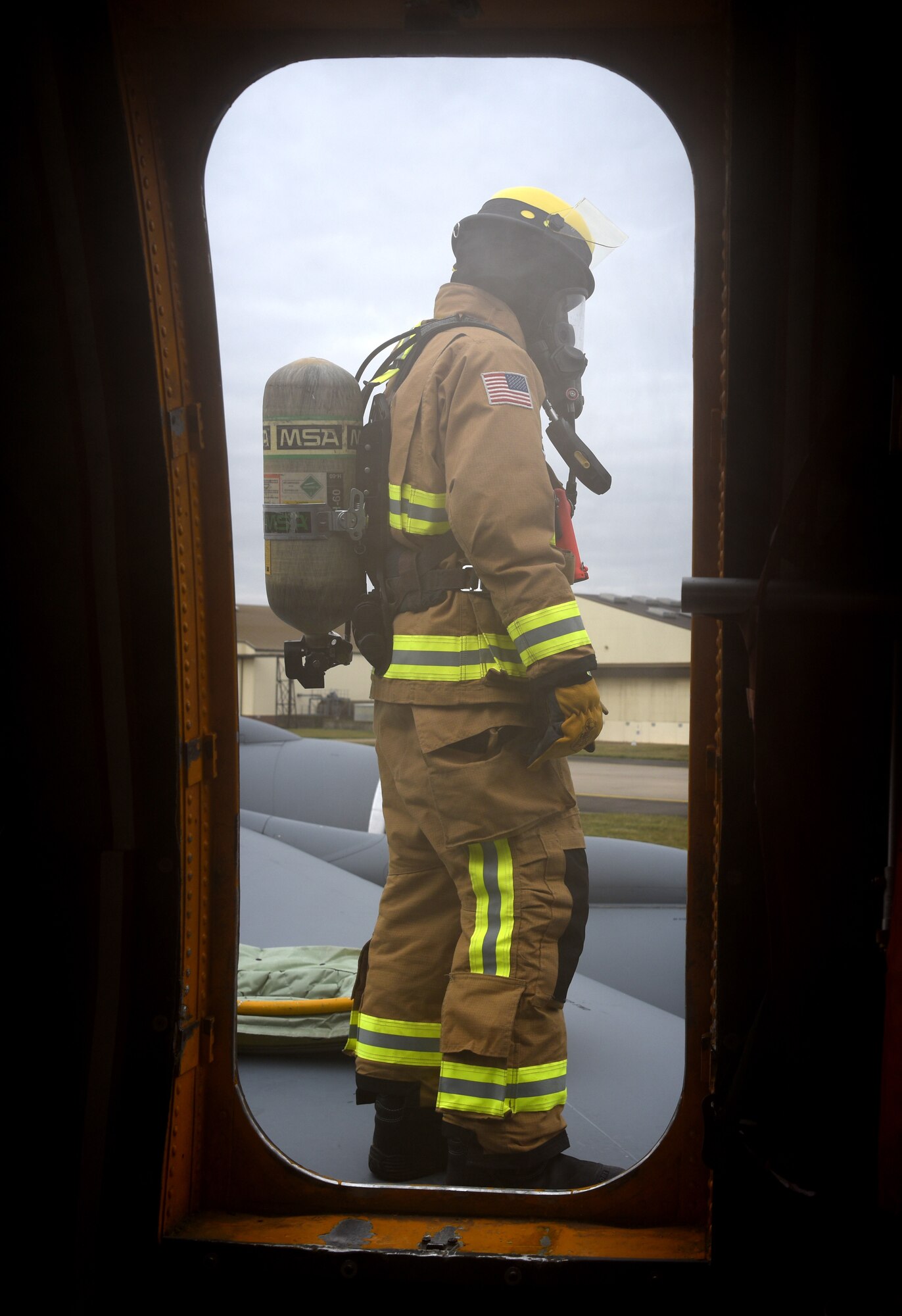 A firefighter with the 100th Civil Engineer Squadron prepares to enter a KC-135 Stratotanker during a training exercise simulating a cockpit fire at RAF Mildenhall, England, Oct. 22, 2019. The firefighters had to search for “unaccounted personnel” in and around the aircraft during the simulated fire. (U.S. Air Force photo by Senior Airman Brandon Esau)