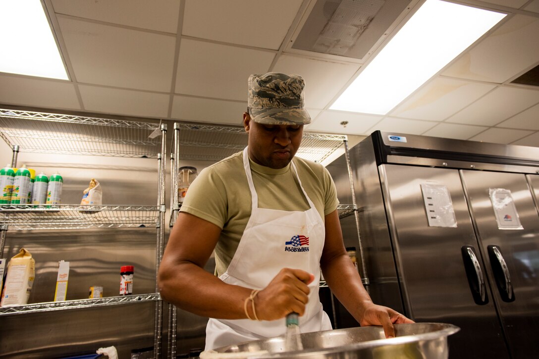 Staff Sgt. Cameron Morrow, 23d Force Support Squadron (FSS) honor guard trainer, stirs cake mix during a Scary Cake Bake-Off Oct. 23, 2019, at Moody Air Force Base, Ga. The event, hosted by the 23d FSS, pitted two teams against each other to bake and design a Halloween-themed cake. In the end, the three judges declared Ight Imma Head Out the winning team. (U.S. Air Force photo by Airman Elijah M. Dority)