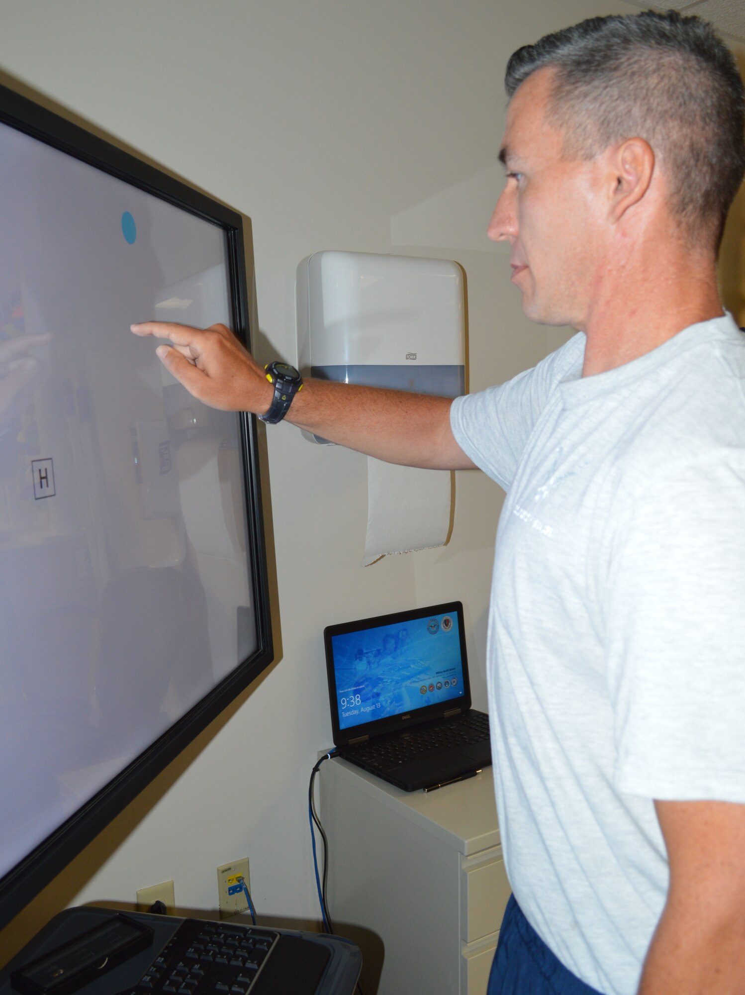 Air Force 1st Lt. Jason Hibbetts practices his cognitive function by touching a moving dot on a video screen Aug. 13 at the Brain Injury Rehabilitation Service at Brooke Army Medical Center at Joint Base San Antonio-Fort Sam Houston. The BIRS provides comprehensive outpatient neurorehabilitation for service members, family members and military retirees recovering from a stroke or other brain injuries using an interdisciplinary approach including physical therapy, occupational therapy, speech language pathology, recreational therapy, psychology, neuropsychology and case management. (Photo by Lori Newman)