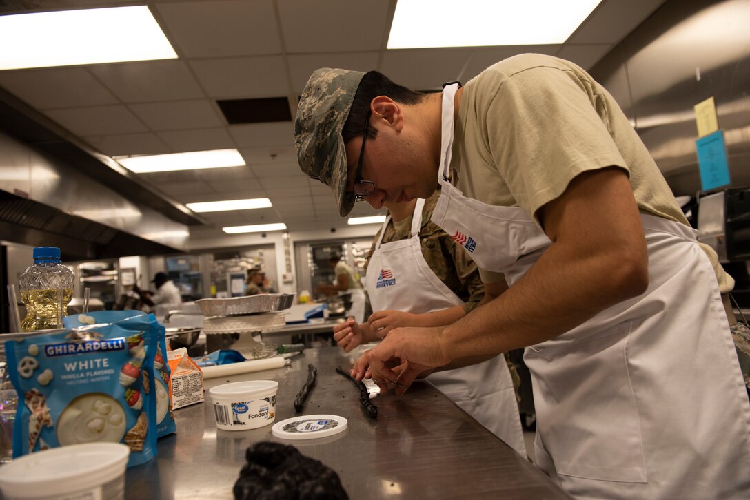 2nd Lt. Dallas Cook, 23d Maintenance Squadron section commander, prepares cake designs during a Scary Cake Bake-Off Oct. 23, 2019, at Moody Air Force Base, Ga. The event, hosted by the 23d Force Support Squadron, pitted two teams against each other to bake and design a Halloween-themed cake. In the end, the three judges declared Ight Imma Head Out the winning team. (U.S. Air Force photo by Airman Elijah M. Dority)